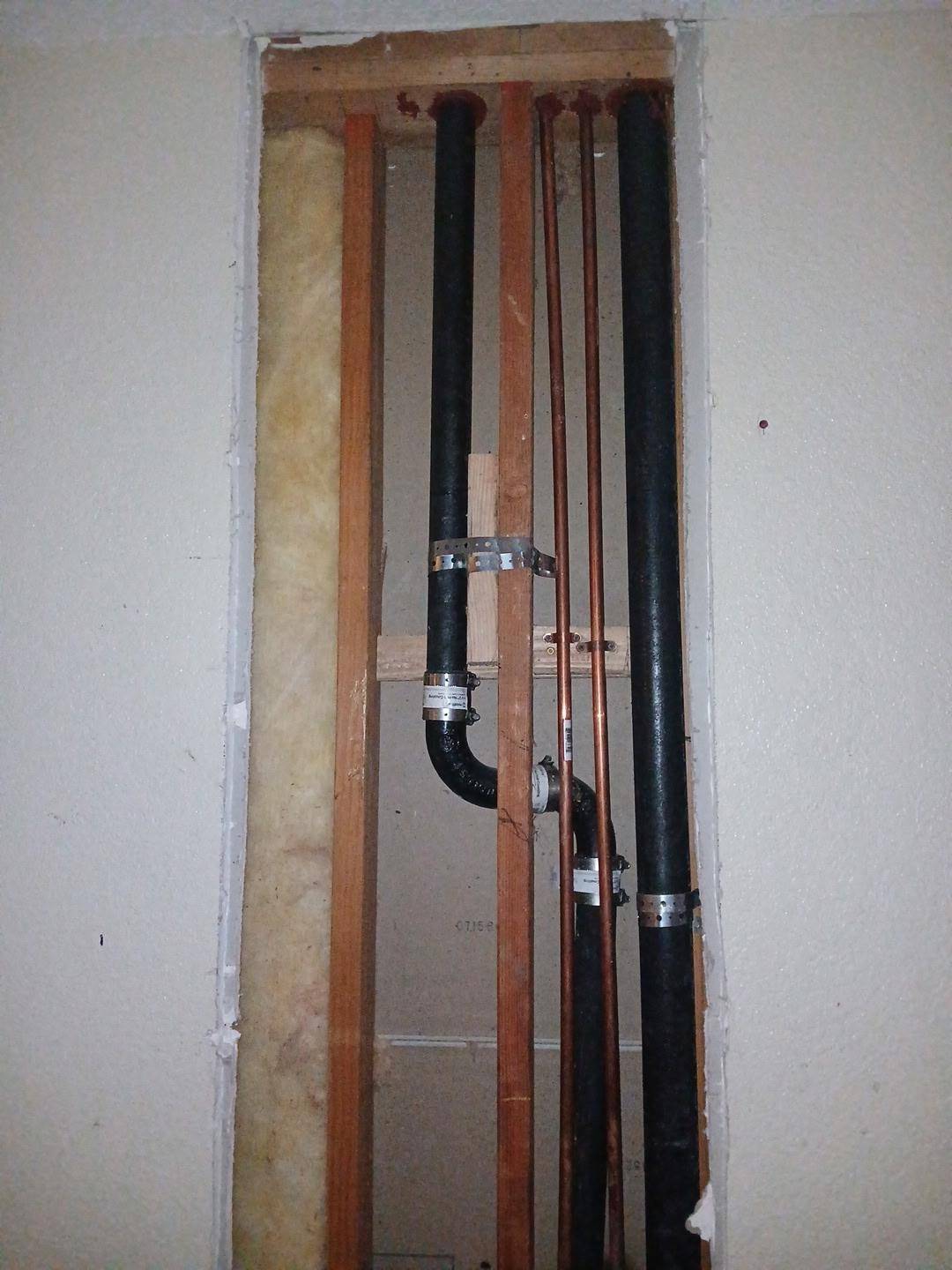 New copper supply lines and ABS drain in an open wall during a repipe
