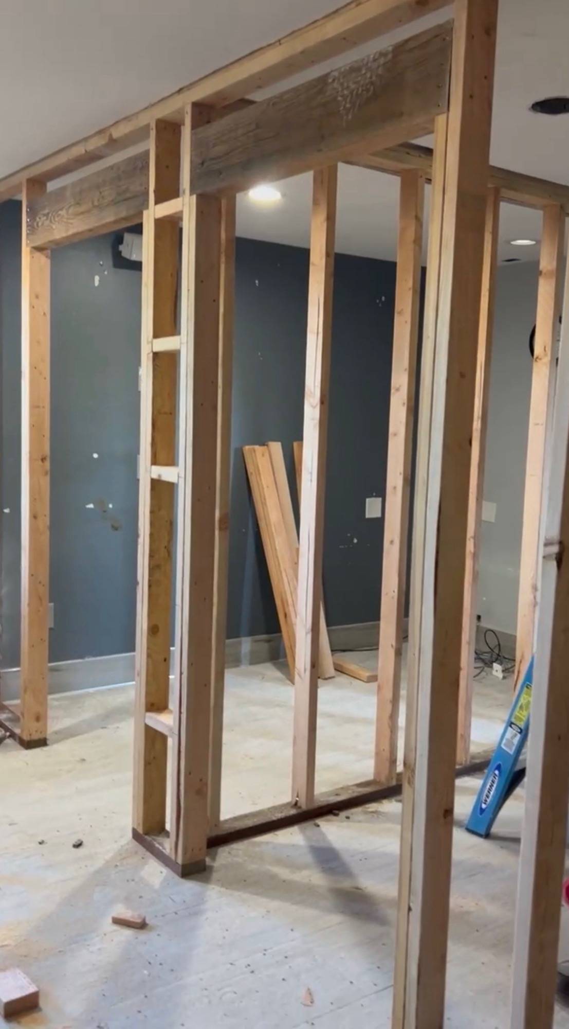 New stud walls and a framed doorway during an interior build-out