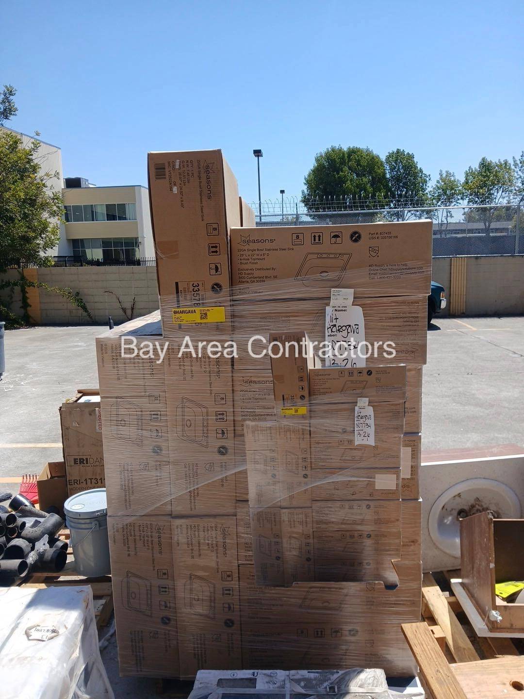 Pallets of boxed stainless steel sinks delivered for a multi-unit kitchen project
