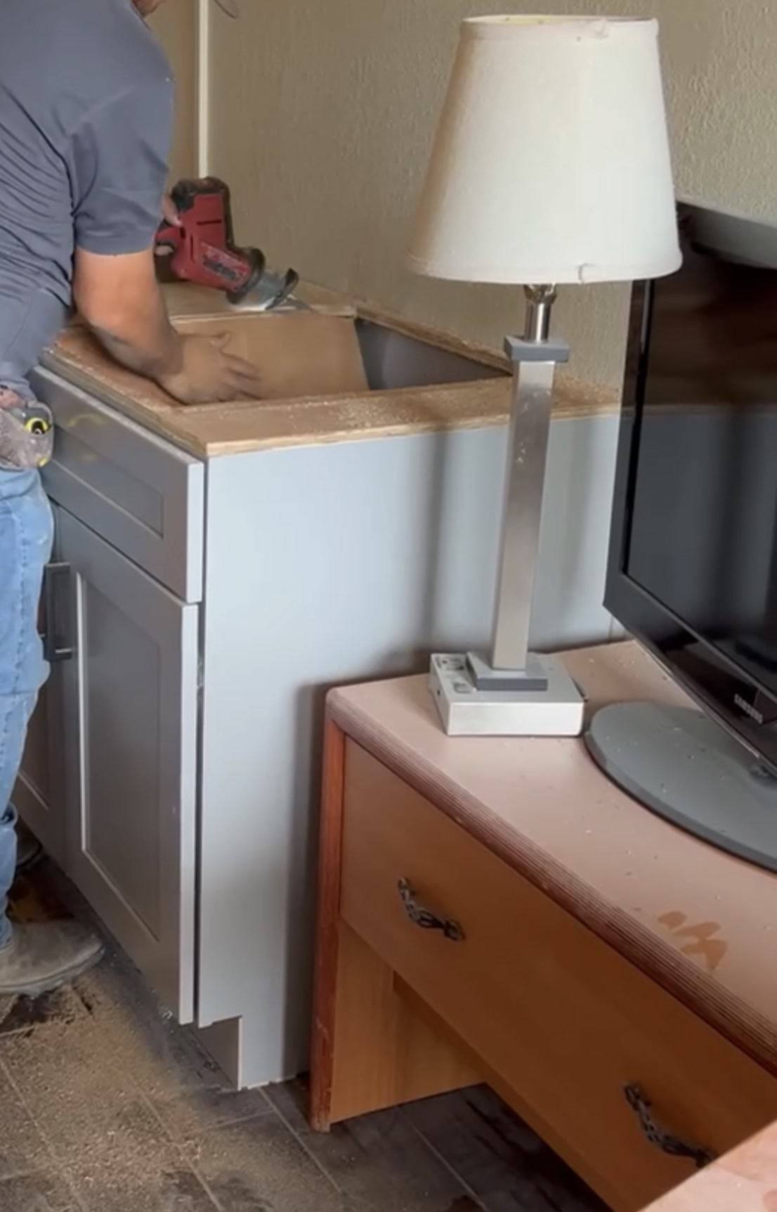 Cutting the sink opening in a new base cabinet during a kitchenette install