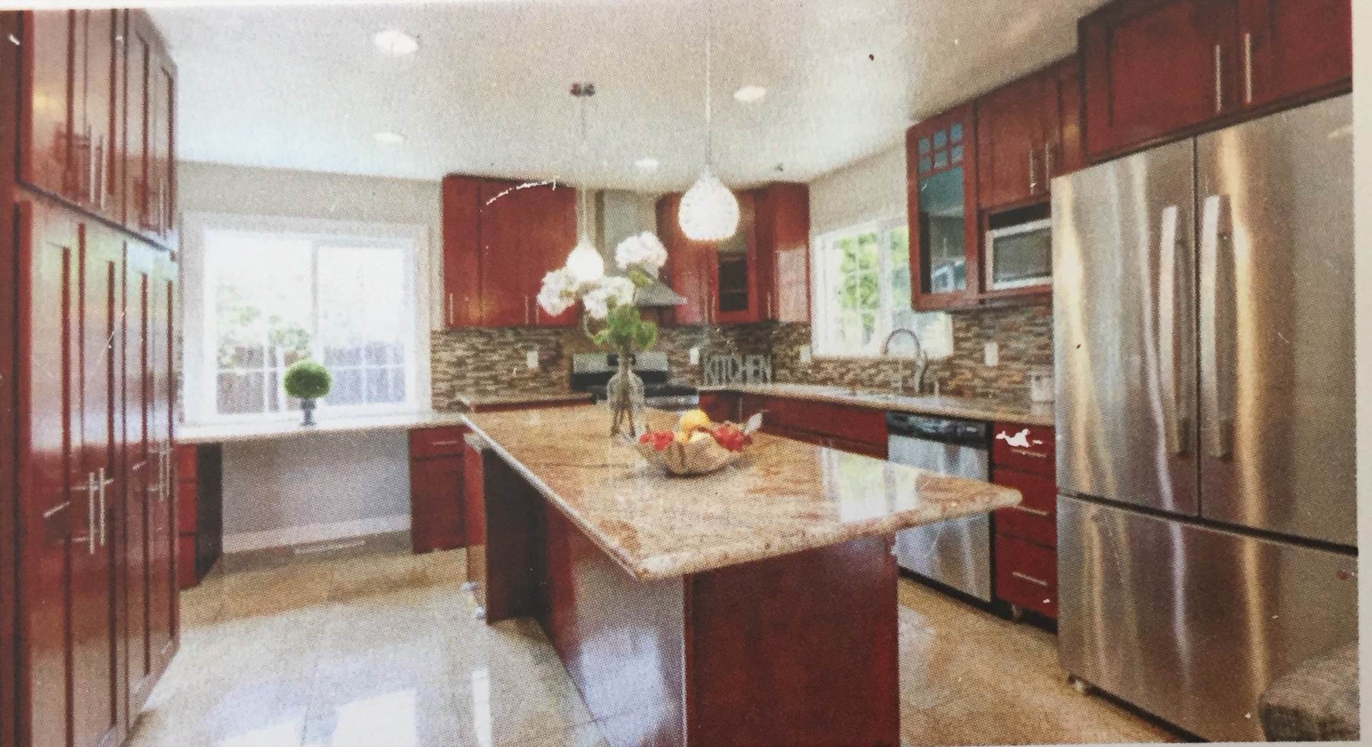 Finished kitchen renovation with cherry shaker cabinets, granite island, and stainless appliances
